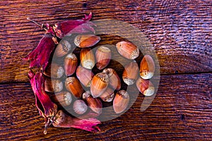 Fresh ripe red hazelnuts on wooden table