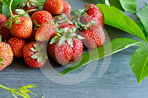 Fresh ripe red strawberries on gray table.