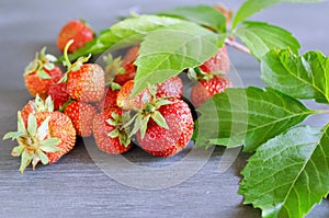 Fresh ripe red strawberries on gray table. Diet, healthy, vegan