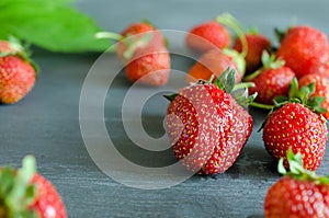 Fresh ripe red strawberries on gray table. Diet, healthy, vegan