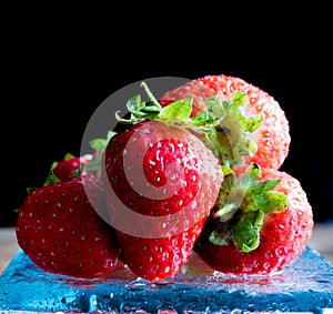 Fresh ripe red strawberries isolated on dark background