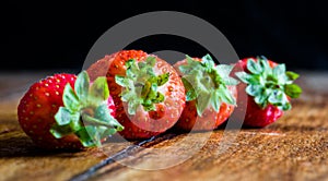 Fresh ripe red strawberries isolated on rustic wooden table