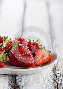 Fresh ripe red strawberries in white plate