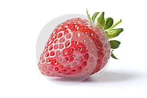 Fresh ripe red strawberry with green leaves on white background with dropped shadow.