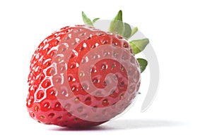 Fresh ripe red strawberry with green leaves on white background with dropped shadow.