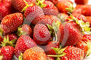 Fresh ripe strawberries are appetising on a white plate