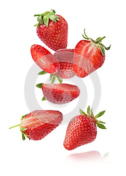 Fresh ripe strawberries falling on white background