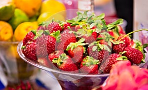 Fresh ripe strawberries in a glass bowl close-up. CAIPIRINHA