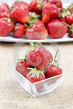 Fresh ripe strawberries in glass bowl