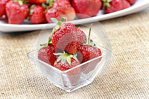 Fresh ripe strawberries in glass bowl