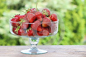 Fresh ripe strawberries in glass bowl