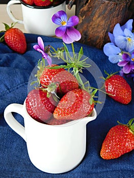 Fresh ripe strawberries in a jug