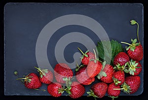 Fresh ripe strawberry on dark background, top view, copy space