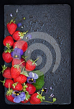 Fresh ripe strawberry on dark background, top view, copy space