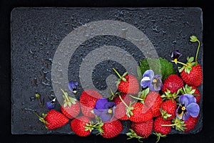 Fresh ripe strawberry on dark background, top view, copy space