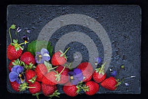 Fresh ripe strawberry on dark background, top view, copy space