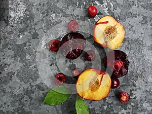 Fresh ripe summer berries and fruits, peaches, apricots, cherry and plum in a round plate on the table