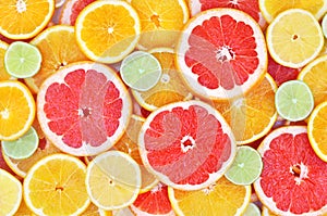 Fresh ripe sweet citrus fruits colorful background: orange, grapefruit, lime, lemon