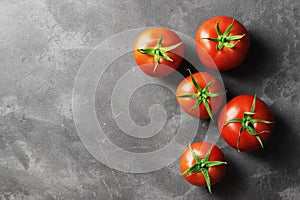 Fresh ripe tomatoes on a concrete background.
