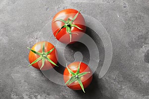 Fresh ripe tomatoes on a concrete background. Top view.