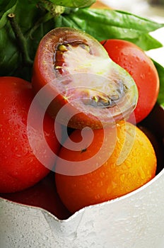 Fresh ripe tomatoes in a spray of water