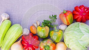 Fresh ripe vegetables appear and disappear, sliding on the linen cloth. Stop motion animation