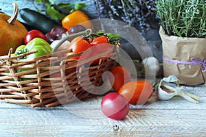 Fresh ripe vegetables and fruits in a basket, on a wooden table