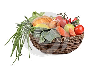 Fresh ripe vegetables and fruits in wicker bowl on white background