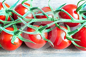 Fresh ripe vine tomatoes with a shallow depth of field on a wood