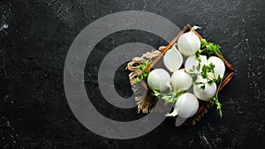 Fresh ripe white onions on black background.