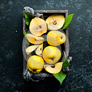 Fresh ripe yellow quince. Fruits in a wooden box