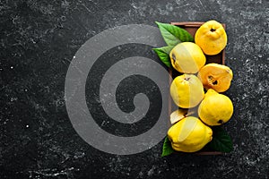 Fresh ripe yellow quince. Fruits in a wooden box.