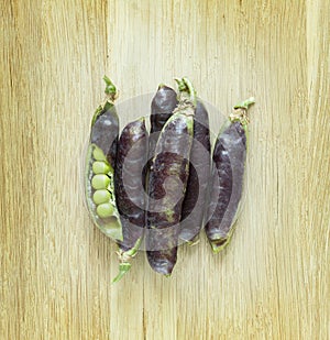 Fresh ripen peas on wooden background photo