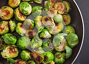 Fresh roasted Brussels sprouts in a black frying pan