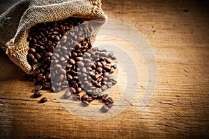 Fresh roasted coffee beans spilling from a sack