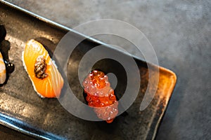 Fresh roe fish eggs sushi wrapped in seaweed and salmon sushi