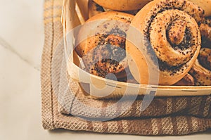 Fresh rolls with poppy a wooden box/fresh pastries concept: fresh rolls with poppy a wooden box, top view