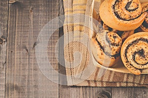 Fresh rolls with poppy a wooden box/fresh rolls with poppy a wooden box on a dark wooden background. Top view and copy space