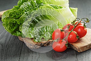 Fresh romain green salad and tomatoes on olive