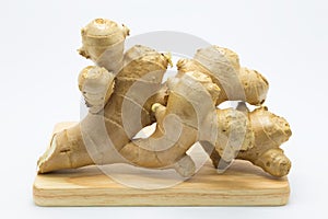 Fresh root ginger on wood board