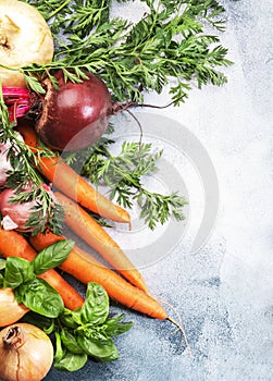 Fresh root vegetables and herbs. Healthy food, autumn cooking concept. Gray background with negative space. Top view