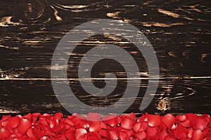 Fresh rose petals on wooden background