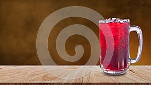 Fresh Roselle juice sweet water and iced in glass on wooden table with dark background, Summer health drinks with ice, Red juice