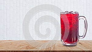 Fresh Roselle juice sweet water and iced in glass on wooden table with white background, Summer health drinks with ice, Red juice