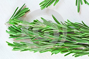 Fresh rosemary twigs on wooden background