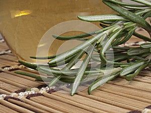 Fresh rosemary with warm massage oil