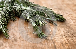 Fresh rosemary on wooden table, closeup