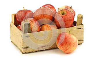 Fresh royal gala apples in a wooden crate