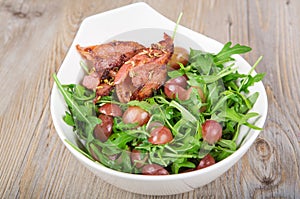 Fresh rucola salad with red grapes