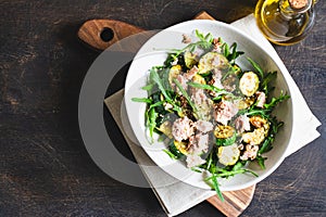 Fresh salad with arugula, baked zucchini and tuna. the concept of healthy and nutritious food